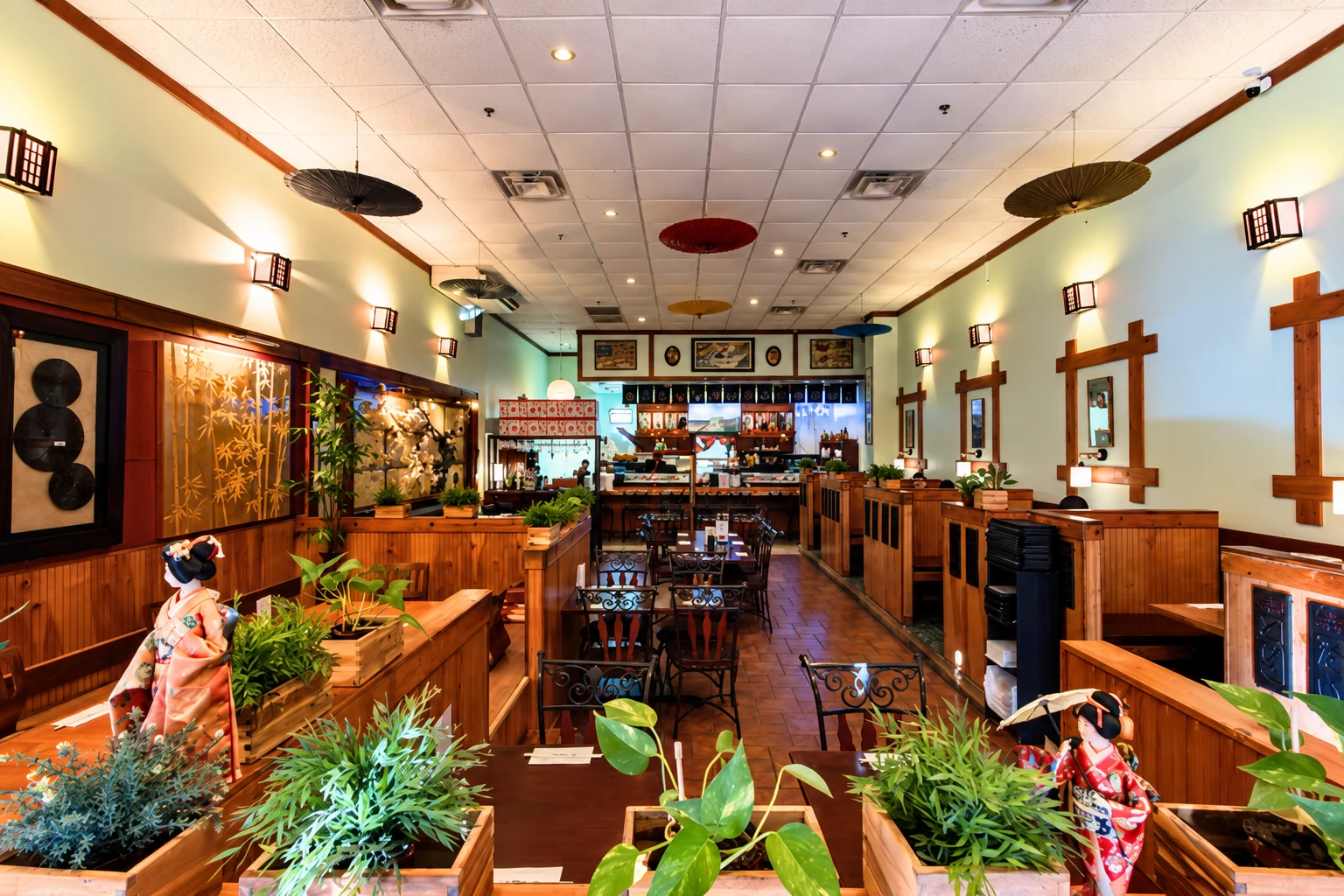 Midori Sushi dining room with wood booths, plants, ceiling umbrellas and a sushi bar