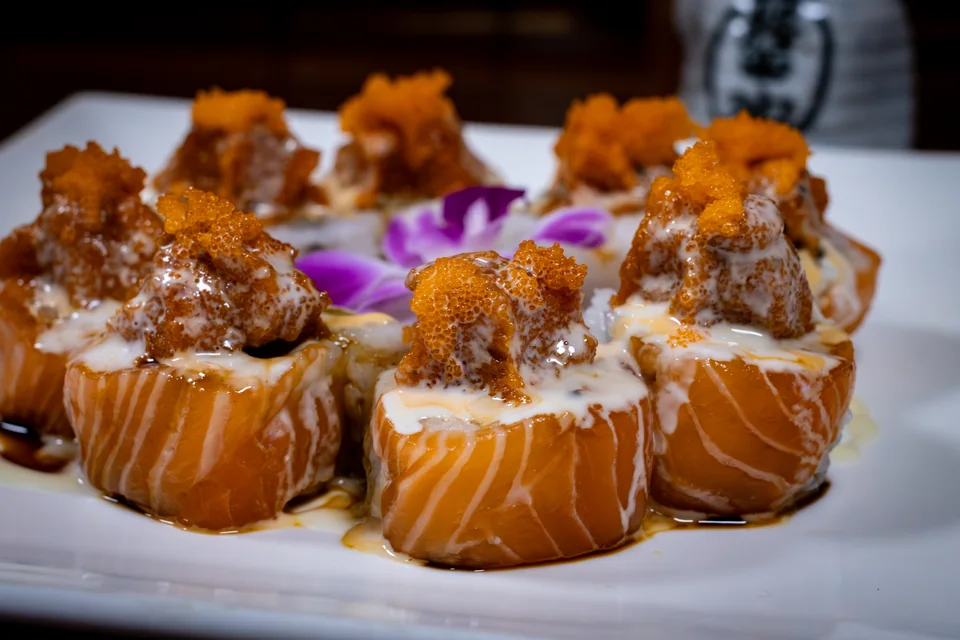 Midori Roll topped with salmon, spicy tuna and masago